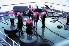 Men in lifejackets on the TEV Wahine deck next to a broken tow cable