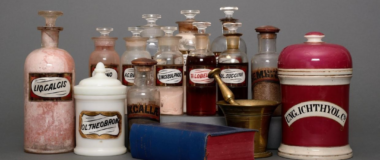 A group of vintage pharmaceutical bottles from the Castle Chemists collection on a grey background.